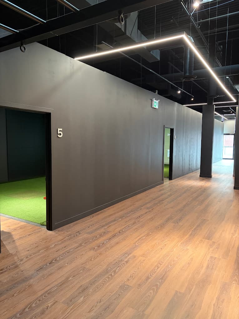 View of golf simulator bays and hall layout at Forged Golf