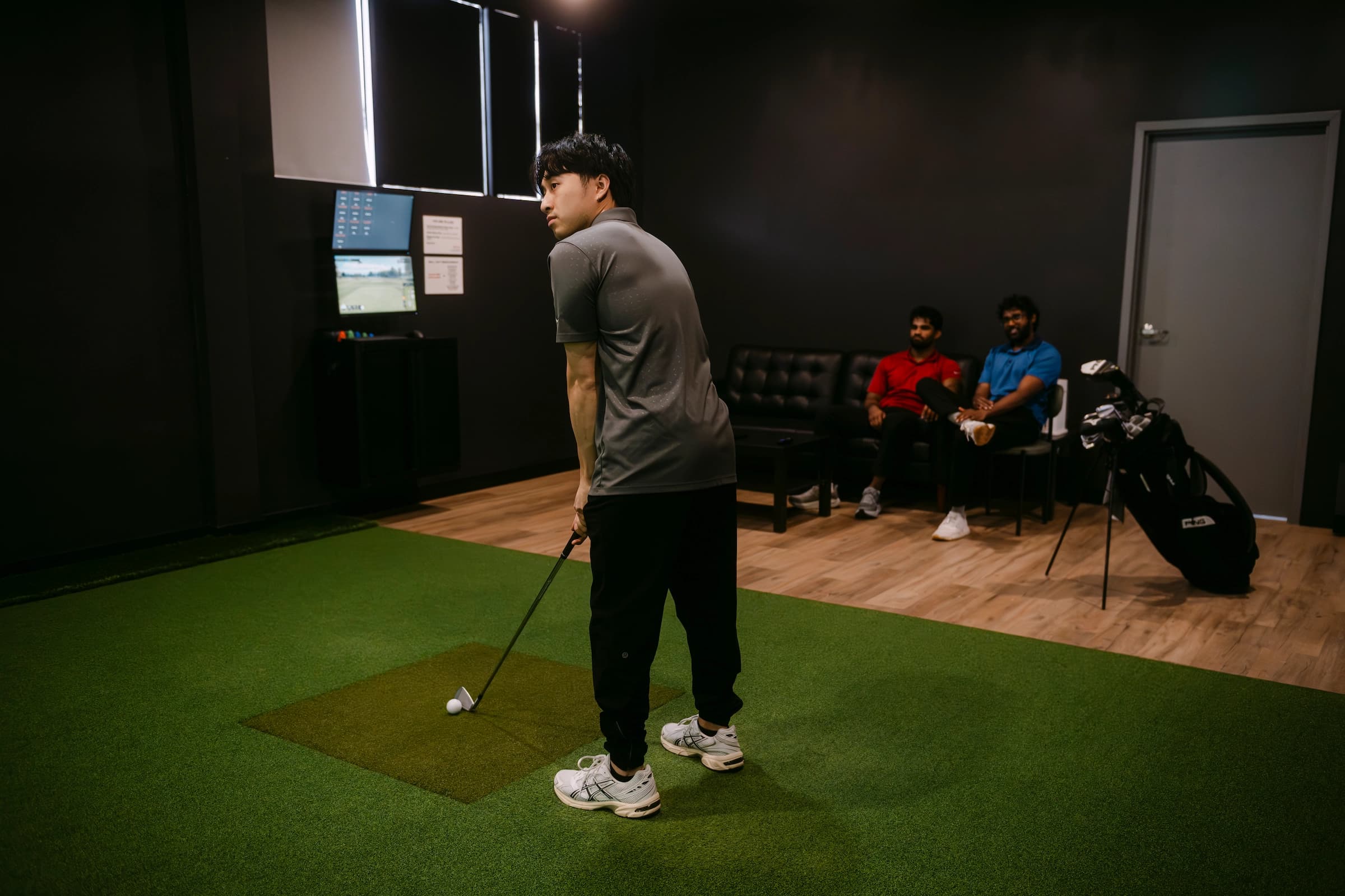 Friends having fun at Forged Golf indoor golf in Mississauga